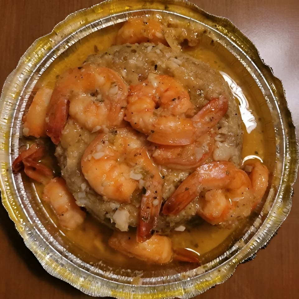 Mofongo with shrimp in garlic sauce, served in a foil container from El Gordo Coqui.